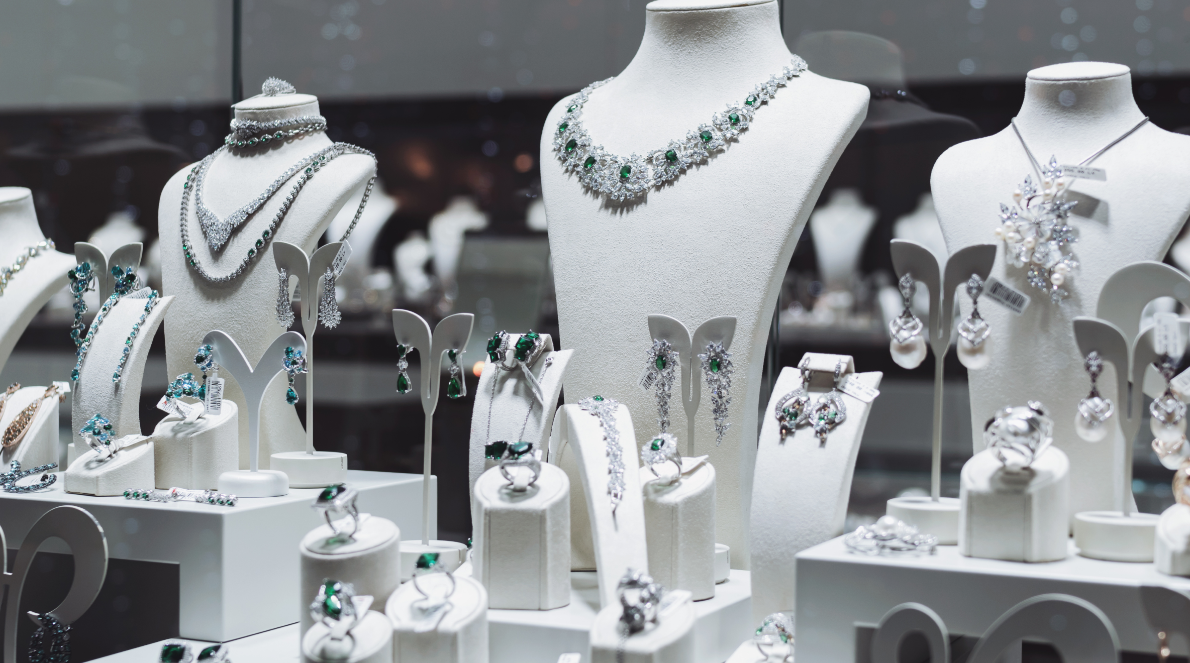  Window display of silver, diamond, and green gemstone jewelry